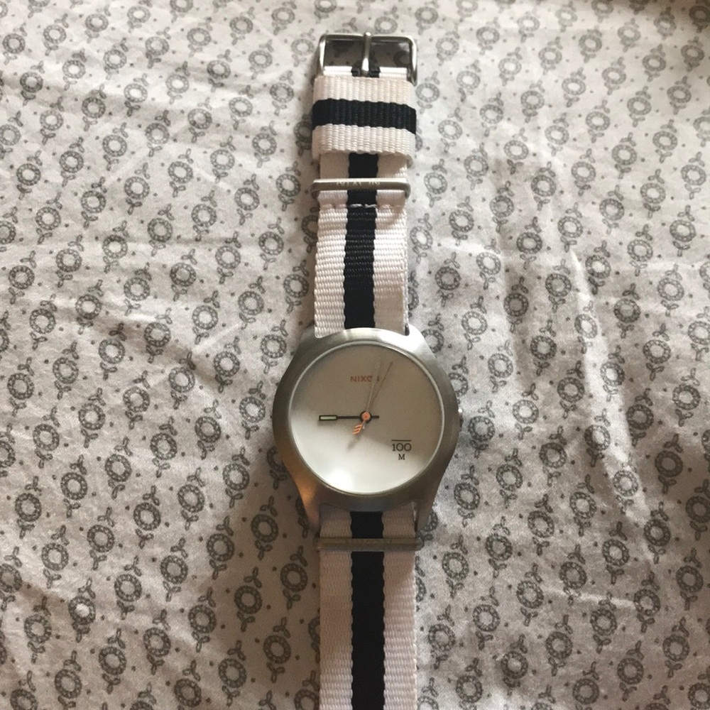 White Nixon watch.